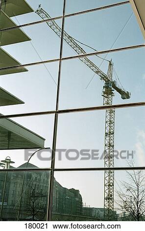 Reflection of crane in office building windows View Large Photo Image Stock Image - Reflection of crane in office building windows. Fotosearch