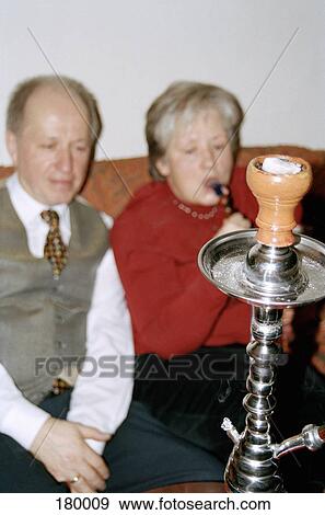 Senior couple smoking water pipe View Large Photo Image Stock Photo - Senior couple smoking water pipe. Fotosearch