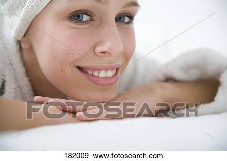 Young woman in bathrobe and towel with head on hands View Large Photo Image Stock Photo - Young woman in bathrobe and towel with head on hands. Fotosearch