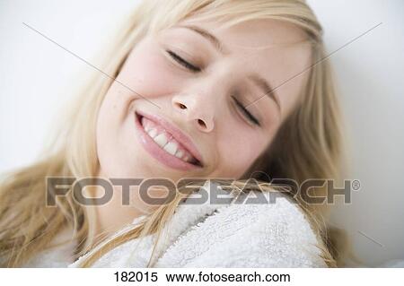 Young woman in bathrobe leaning back with eyes closed View Large Photo Image Stock Photography - Young woman in bathrobe leaning back with eyes closed. Fotosearch