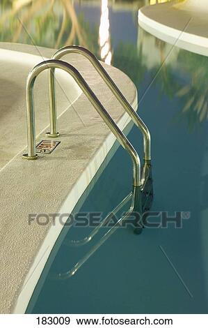 Ladder by swimming pool at luxury resort View Large Photo Image Stock Photo - Ladder by swimming pool at luxury resort. Fotosearch