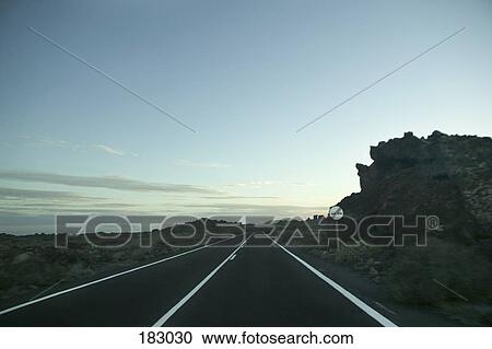 Road sign by two lane highway at dusk View Large Photo Image Stock Image - Road sign by two lane highway at dusk. Fotosearch