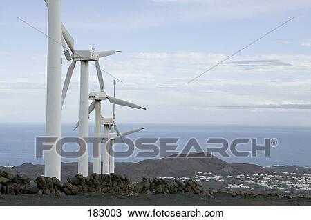Row of wind turbines on hill View Large Photo Image Stock Image - Row of wind turbines on hill. Fotosearch