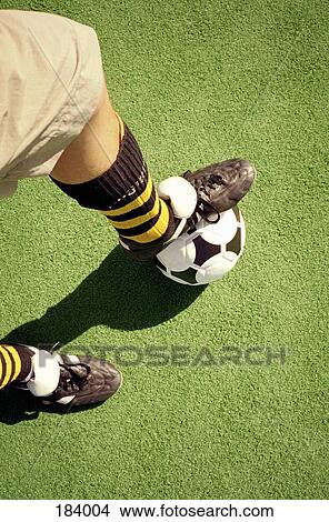 Man with foot on soccer ball View Large Photo Image Picture - Man with foot on soccer ball. Fotosearch