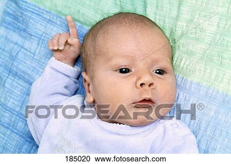 Stock Image - Newborn baby lying down on blanket. Fotosearch