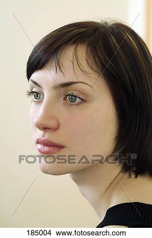 Over the shoulder view of young woman with short brown hair looking away View Large Photo Image Picture - Over the shoulder view of young woman with short brown hair looking away. Fotosearch
