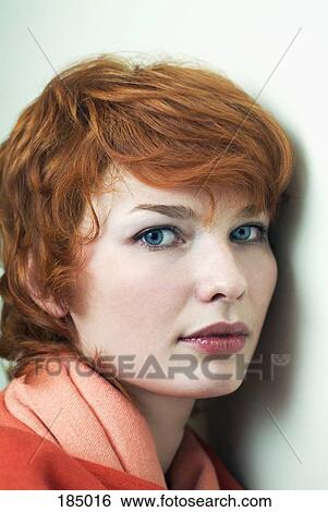 Young woman with red hair and head turned View Large Photo Image Stock Photograph - Young woman with red hair and head turned. Fotosearch