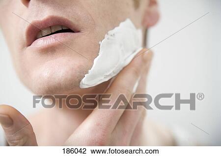 Close-up of man applying shaving cream View Large Photo Image Stock Image - Close-up of man applying shaving cream. Fotosearch