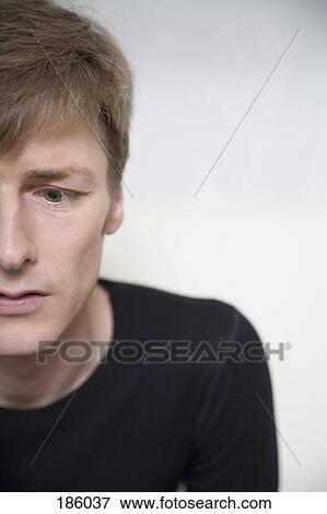 Close-up of man looking away View Large Photo Image Stock Photo - Close-up of man looking away. Fotosearch