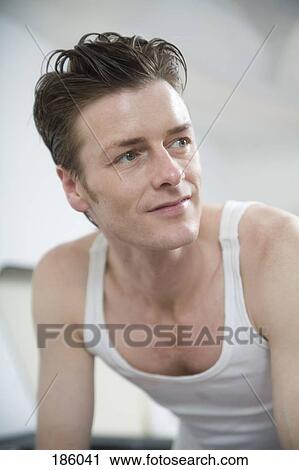 Man in tank top with hair slicked back looking away View Large Photo Image Stock Image - Man in tank top with hair slicked back looking away. Fotosearch