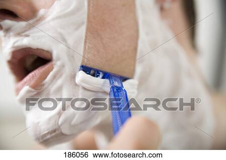 Stock Photograph - Side view of man shaving. Fotosearch