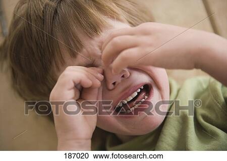 Young boy crying with hands covering face View Large Photo Image Stock Image - Young boy crying with hands covering face. Fotosearch