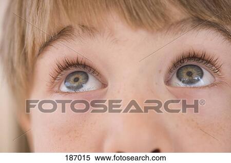 Stock Photography - Young boy looking up. Fotosearch