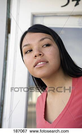 Young Native American woman standing at front door View Large Photo Image Stock Photo - Young Native American woman standing at front door. Fotosearch
