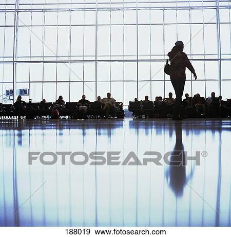 People sitting in airport lobby View Large Photo Image Stock Photo - People sitting in airport lobby. Fotosearch