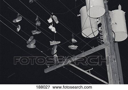 Shoes hanging from power lines View Large Photo Image Stock Photo - Shoes hanging from power lines. Fotosearch