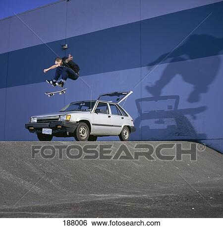 Skateboarder doing stunts View Large Photo Image Stock Photograph - Skateboarder doing stunts. Fotosearch