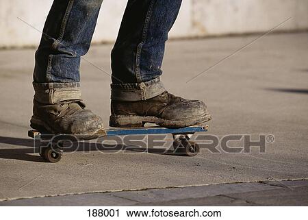 Young man on skateboard View Large Photo Image Stock Image - Young man on skateboard. Fotosearch