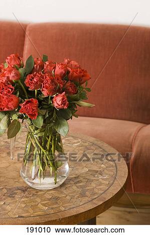 Red roses on table in living room View Large Photo Image Stock Image - Red roses on table in living room. Fotosearch