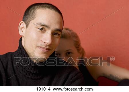 Woman hiding behind man View Large Photo Image Picture - Woman hiding behind man. Fotosearch