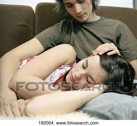 Stock Photo - Teenage girl lying in lap of teenage boy. Fotosearch - Search Stock Images, Mural Photographs, Pictures, and Clipart Photos