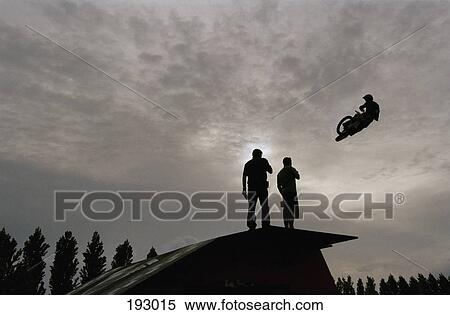 Person performing stunt on motorcycle in mid-air View Large Photo Image Stock Photography - Person performing stunt on motorcycle in mid-air. Fotosearch