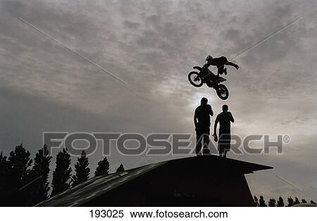 Person riding motorcycle and performing stunt View Large Photo Image Stock Photography - Person riding motorcycle and performing stunt. Fotosearch