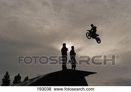 Person riding over jump on motorcycle View Large Photo Image Stock Photo - Person riding over jump on motorcycle. Fotosearch