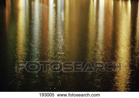 Reflection of colored lights on water at night View Large Photo Image Stock Photography - Reflection of colored lights on water at night. Fotosearch