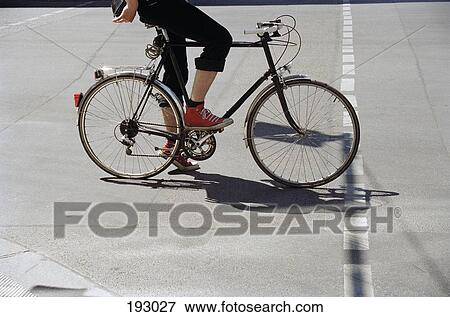 Stock Photo - Young woman on bicycle. Fotosearch