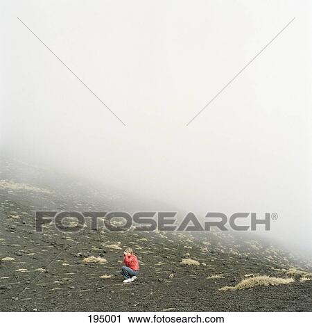 A woman taking a photograph on a foggy hillside View Large Photo Image Stock Image - A woman taking a photograph on a foggy hillside. Fotosearch