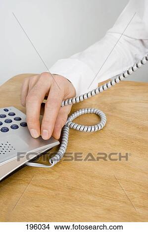 A man holding a telephone cord View Large Photo Image Picture - A man holding a telephone cord. Fotosearch