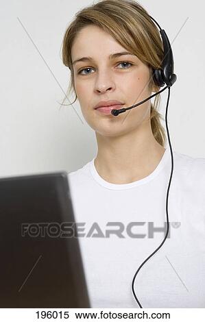 A woman wearing a headset View Large Photo Image Stock Photography - A woman wearing a headset. Fotosearch