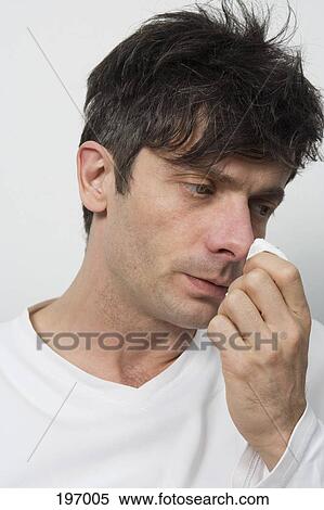 A disheveled man wiping his nose View Large Photo Image Stock Photography - A disheveled man wiping his nose. Fotosearch