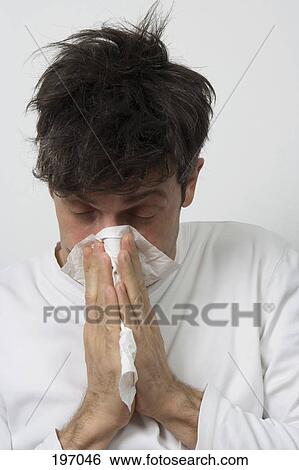 A man blowing his nose View Large Photo Image Stock Photograph - A man blowing his nose. Fotosearch