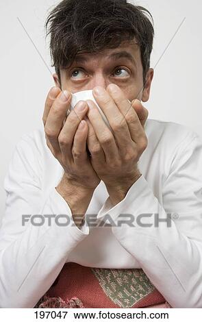 Stock Photo - A man drinking a cup of tea. Fotosearch