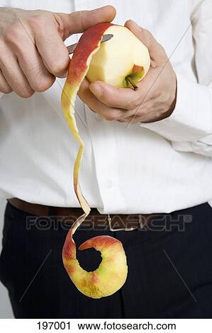A man peeling an apple View Large Photo Image Stock Image - A man peeling an apple. Fotosearch