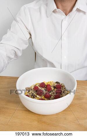A man with a bowl of cereal View Large Photo Image Stock Image - A man with a bowl of cereal. Fotosearch