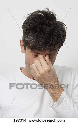 A man with a sinus headache View Large Photo Image Picture - A man with a sinus headache. Fotosearch