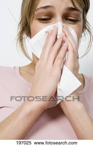 A woman blowing her nose View Large Photo Image Stock Photography - A woman blowing her nose. Fotosearch
