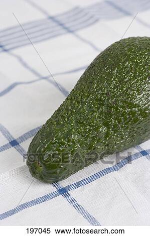 Stock Photography - An avocado on a tablecloth. Fotosearch