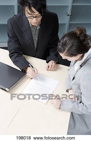 A man and a woman having a discussion in a conference room View Large Photo Image Stock Photo - A man and a woman having a discussion in a conference room. Fotosearch