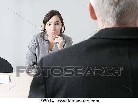 A man and a woman in a business meeting View Large Photo Image Picture - A man and a woman in a business meeting. Fotosearch