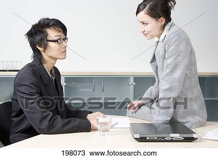 A man and woman having a business meeting in a conference room View Large Photo Image Stock Image - A man and woman having a business meeting in a conference room. Fotosearch