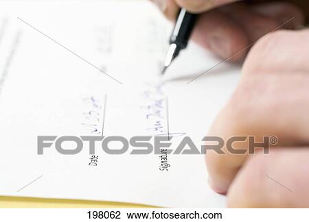 Stock Image - A person signing a legal document. Fotosearch