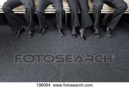 Four businesspeople sitting on a bench View Large Photo Image Picture - Four businesspeople sitting on a bench. Fotosearch