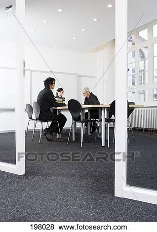 Three people having a meeting in a conference room View Large Photo Image Stock Photo - Three people having a meeting in a conference room. Fotosearch