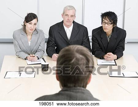 Stock Image - Three people interviewing a job applicant. Fotosearch
