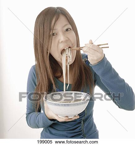 A Japanese woman eating noodles View Large Photo Image Stock Photography - A Japanese woman eating noodles. Fotosearch