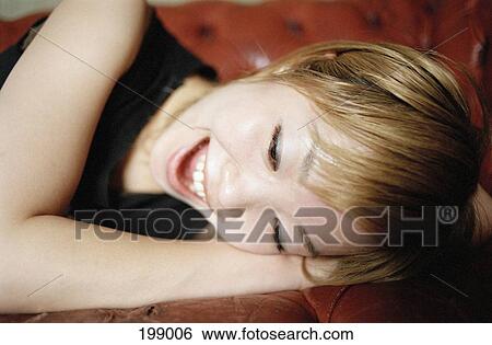 A Japanese woman lying on her side, smiling View Large Photo Image Stock Photograph - A Japanese woman lying on her side, smiling. Fotosearch